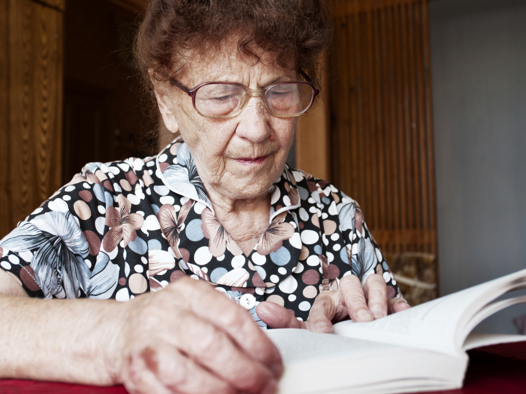 Elderly lady reading a book.