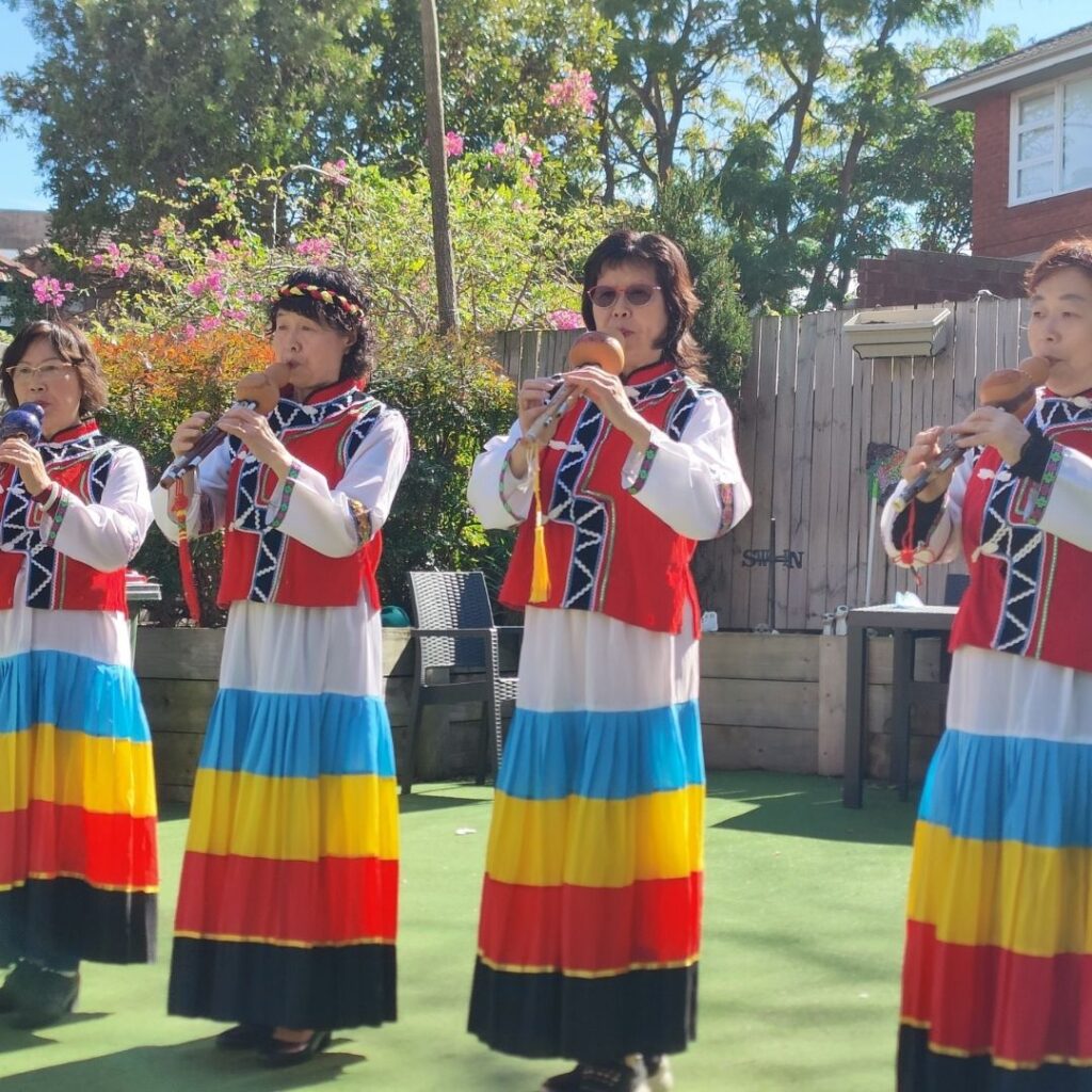 Group of flute players in traditional dreses.